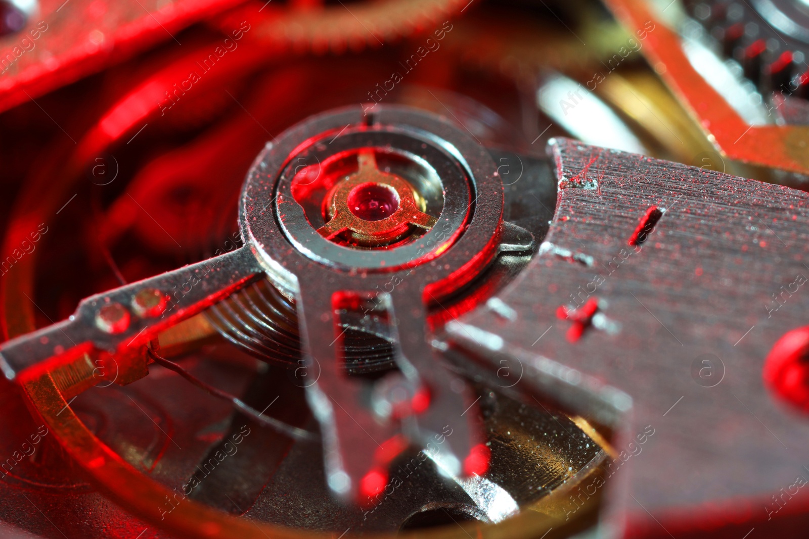 Photo of Mechanism of vintage wrist watch as background, closeup. Color toned