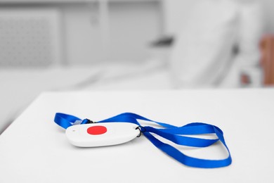 Photo of Emergency call button on white table in hospital