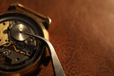 Photo of Mechanism of vintage wrist watch and tool on table, closeup. Space for text