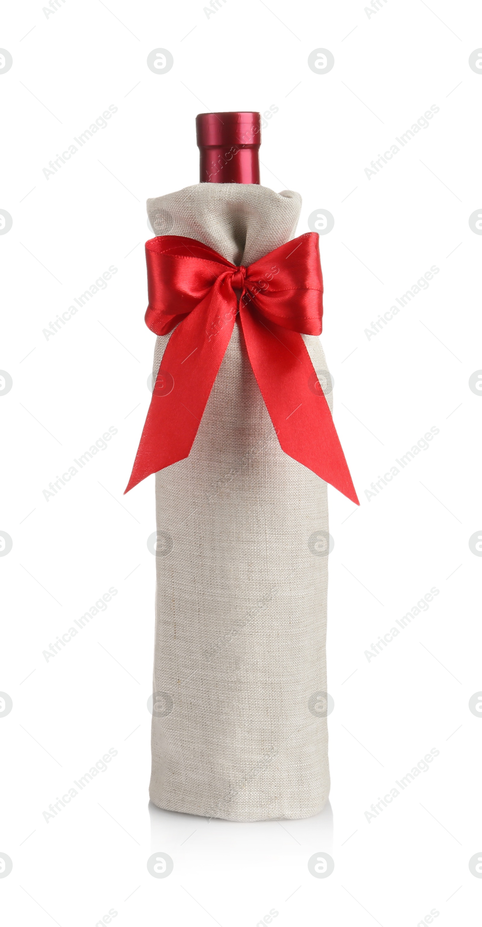 Photo of Wine bottle in burlap package with red ribbon isolated on white