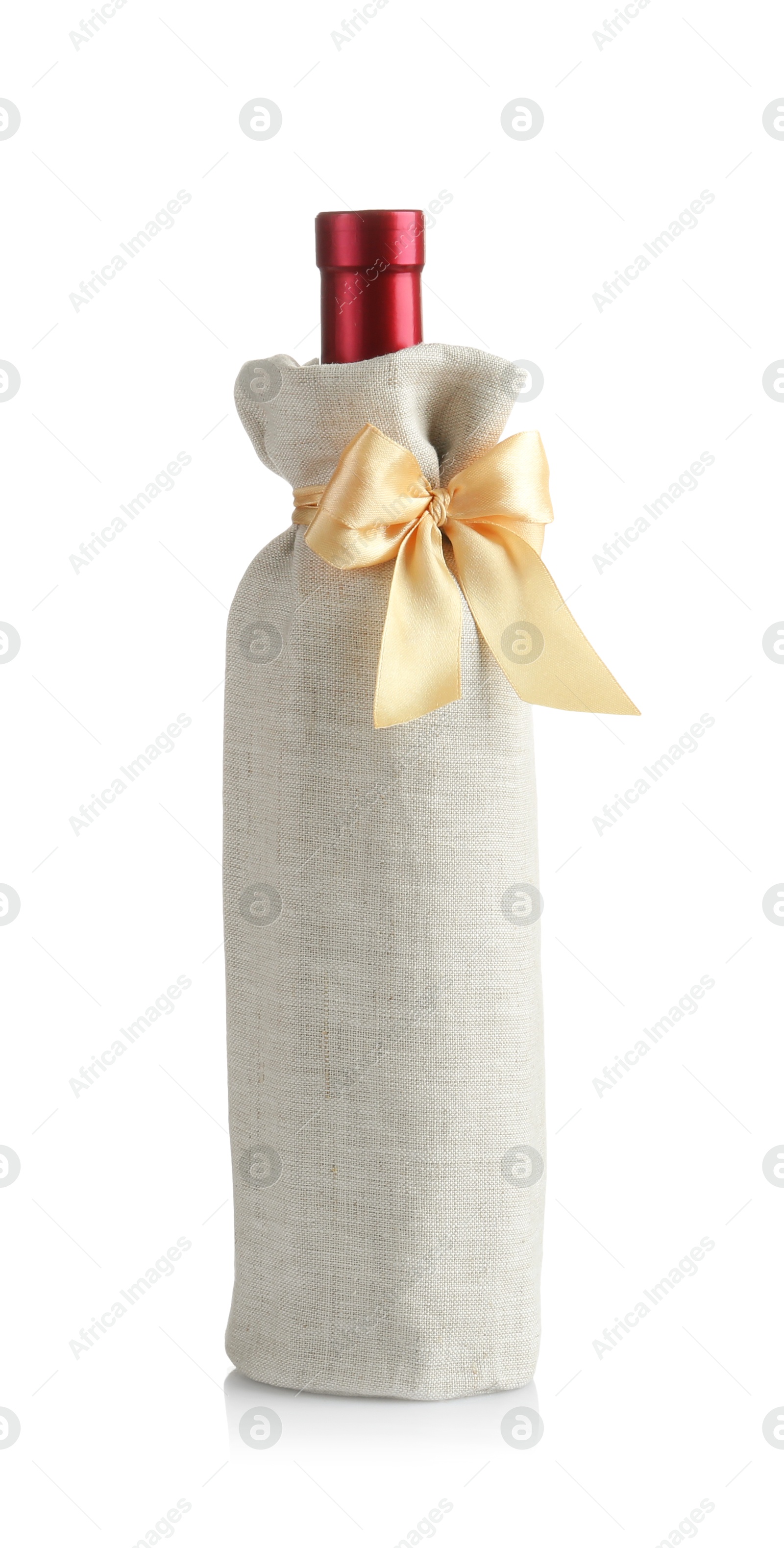 Photo of Wine bottle in burlap package with ribbon isolated on white