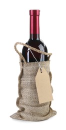 Photo of Wine bottle in burlap bag with cardboard tag isolated on white