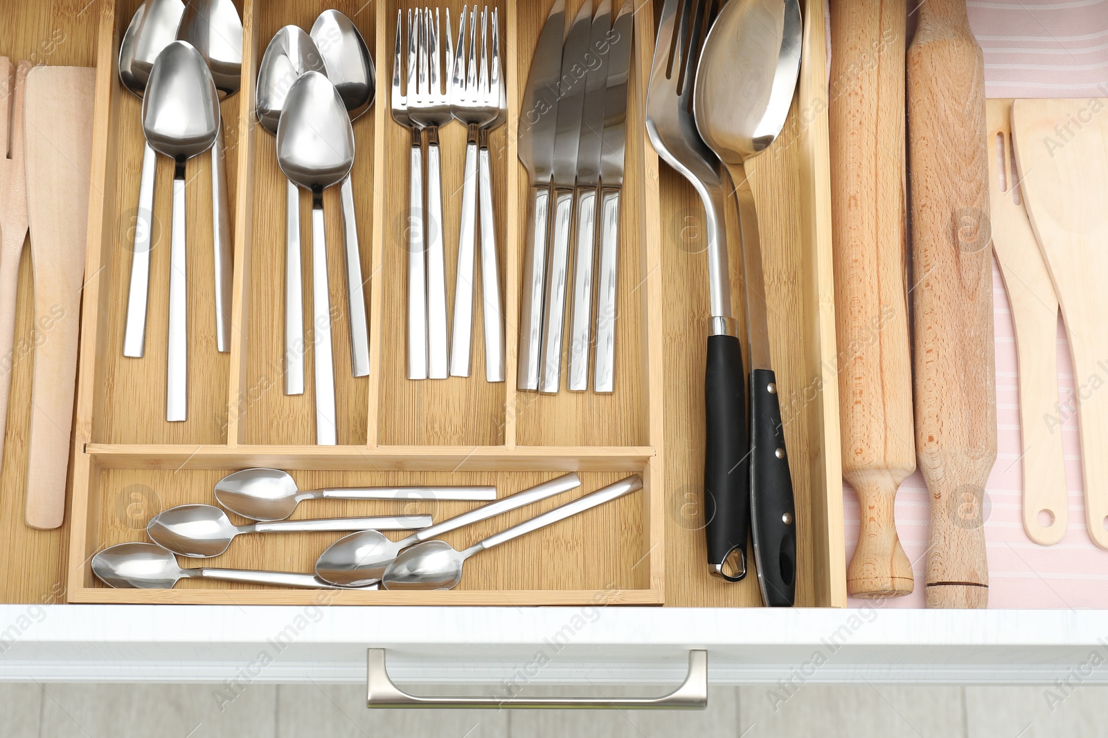 Photo of Box with cutlery in drawer, top view. Kitchen utensils storage