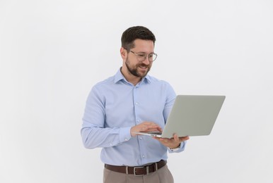 Photo of Portrait of smiling businessman with laptop on white background