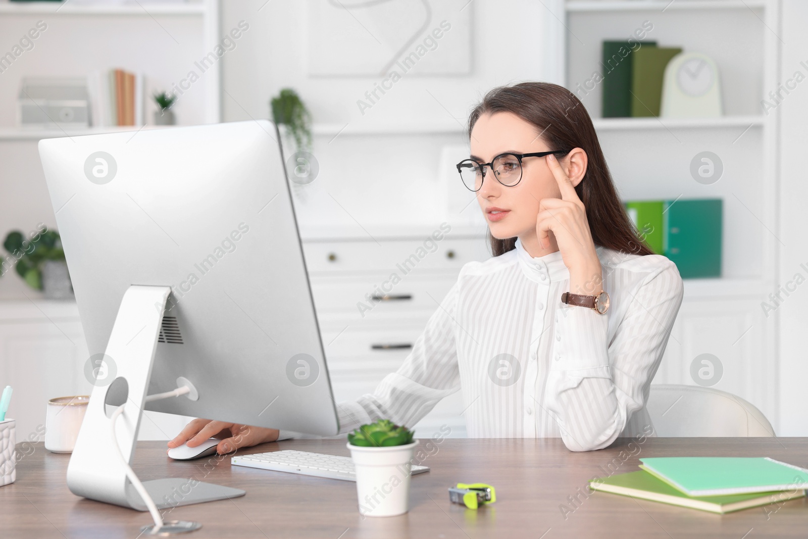 Photo of Beautiful businesswoman working at table in office