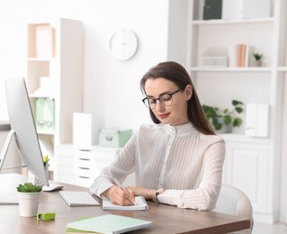 Beautiful businesswoman working at table in office