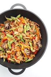 Photo of Stir-fry sea food in wok on white background, top view