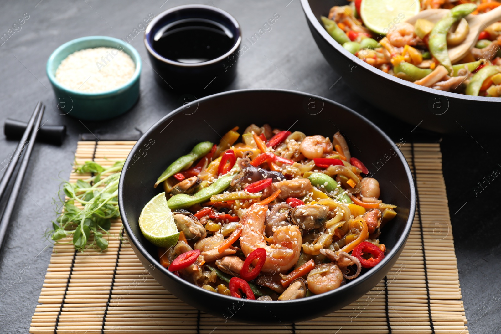 Photo of Stir-fry sea food served on grey table