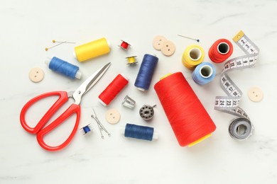 Photo of Flat lay composition with different sewing supplies on white table