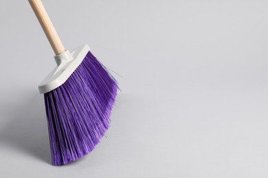 Photo of One cleaning broom on grey background, space for text