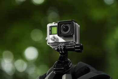 Modern action camera with mount on helmet outdoors, closeup