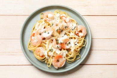 Photo of Delicious pasta with shrimps on white wooden table, top view