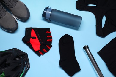 Flat lay composition with cycling accessories a on light blue background