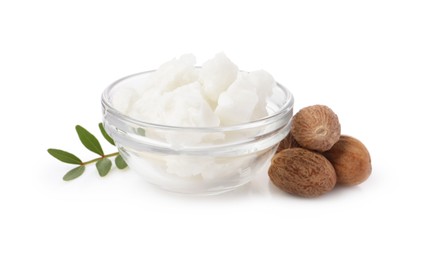 Photo of Shea butter in bowl and nuts isolated on white