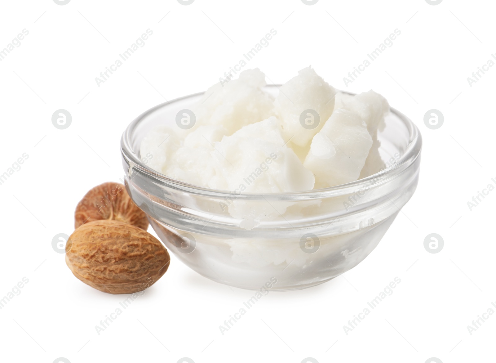 Photo of Shea butter in bowl and nuts isolated on white