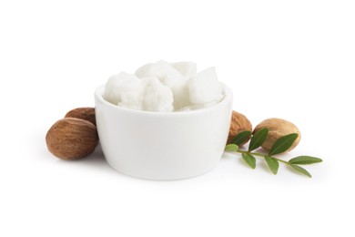 Photo of Shea butter in bowl and nuts isolated on white