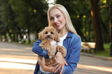 Photo of Beautiful young woman with cute dog in park