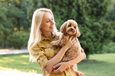 Photo of Beautiful young woman with cute dog in park