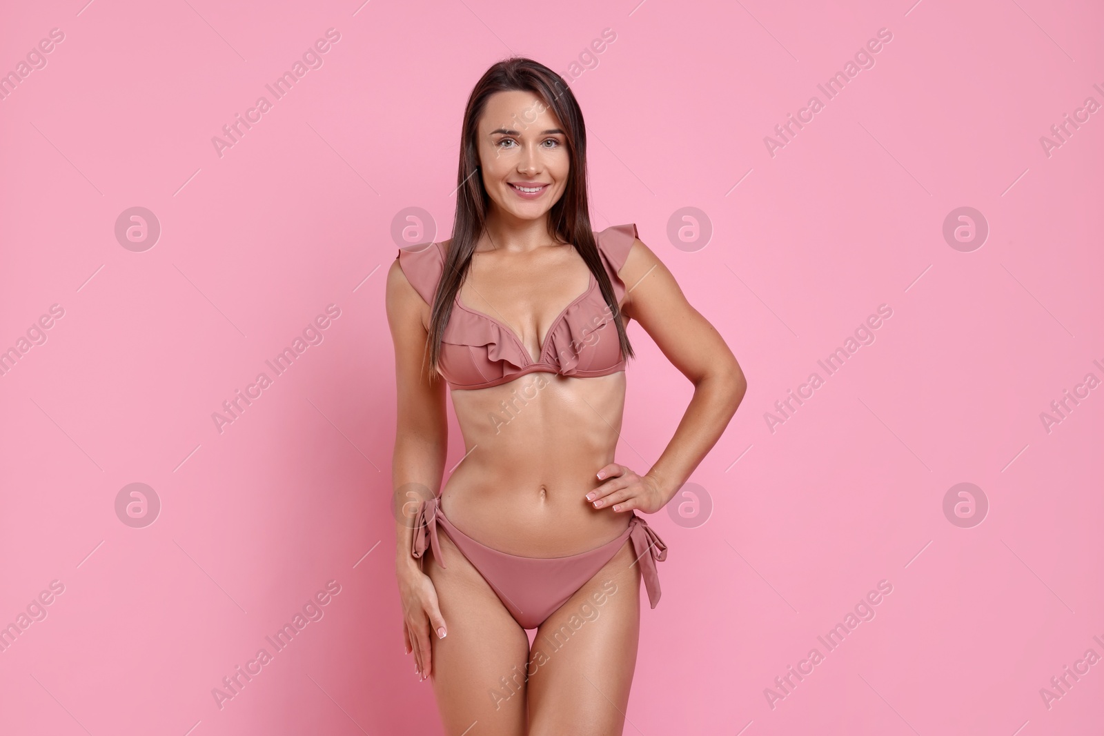 Photo of Woman in stylish bikini on pink background