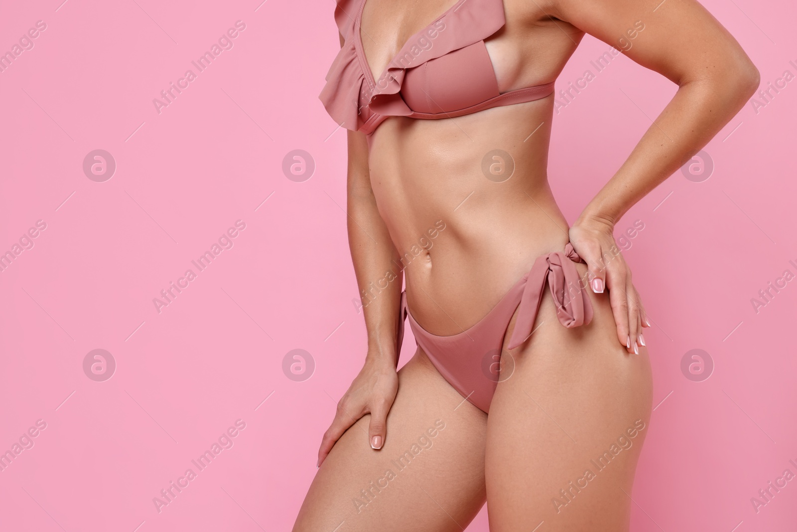 Photo of Woman in stylish bikini on pink background, closeup. Space for text