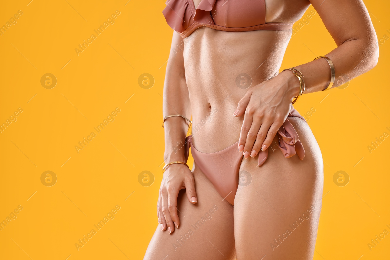 Photo of Woman in stylish bikini on orange background, closeup. Space for text