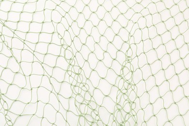 Photo of One green fishing net isolated on white, top view