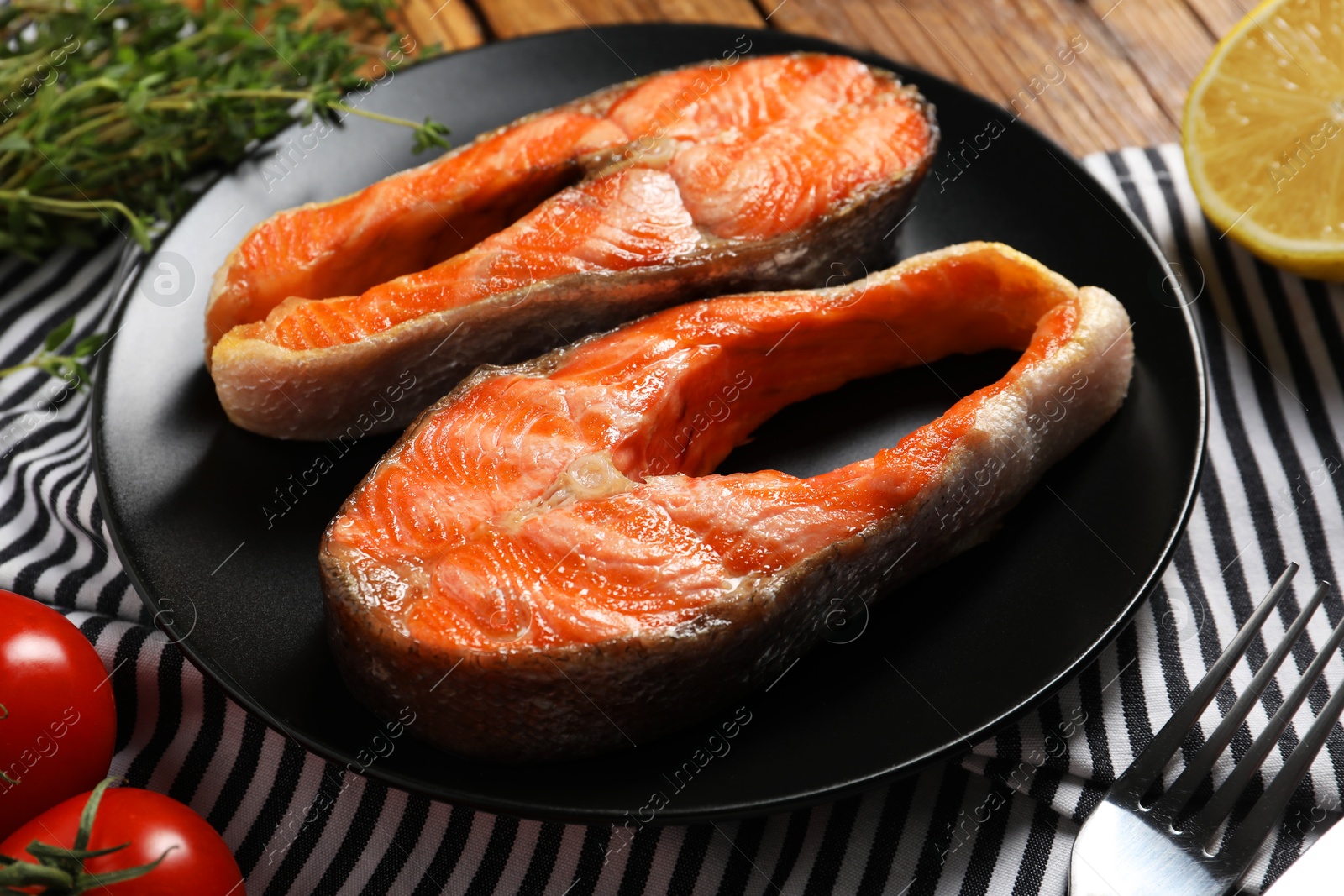 Photo of Tasty grilled salmon steaks on table, closeup