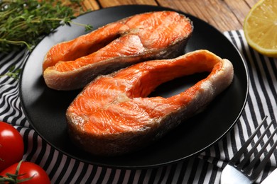 Photo of Tasty grilled salmon steaks on table, closeup