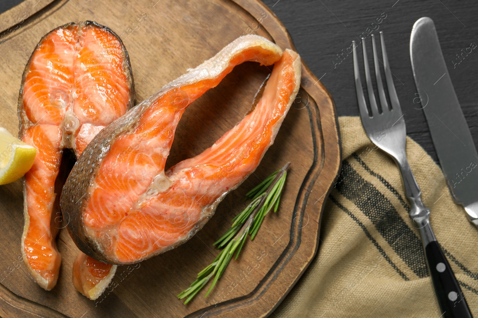 Photo of Tasty grilled salmon steaks served on table, flat lay