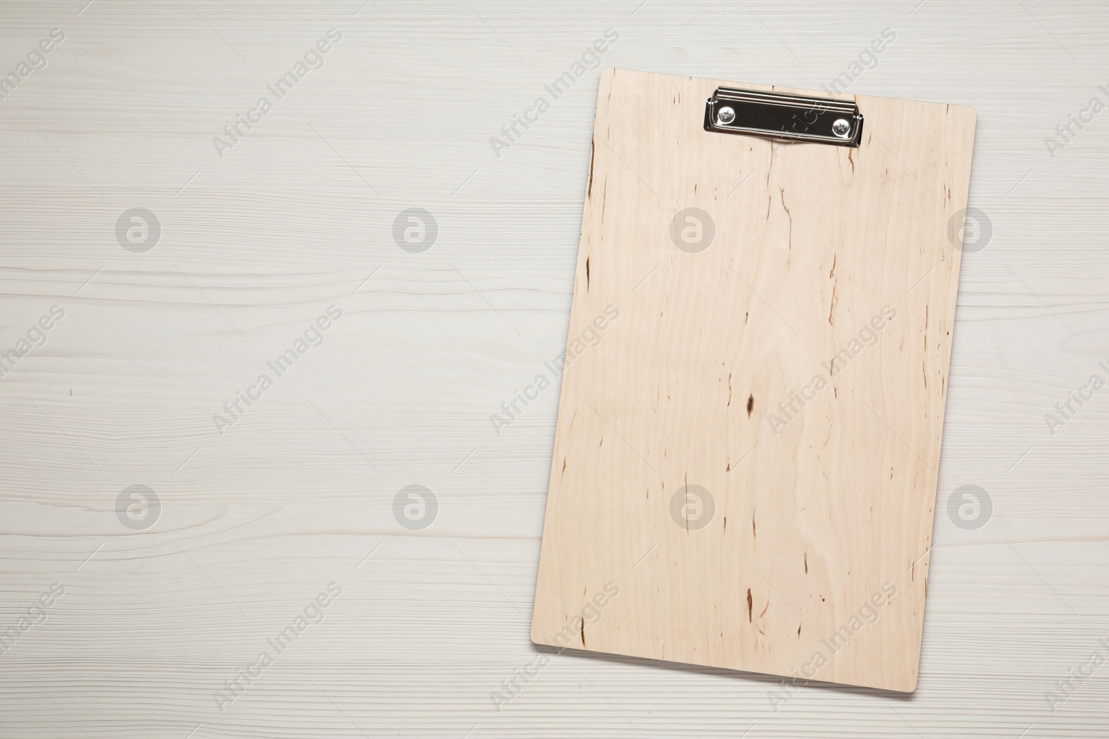 Photo of One clipboard on wooden table, top view. Space for text