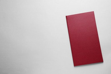 Photo of Hardcover book on light grey background, top view. Space for text