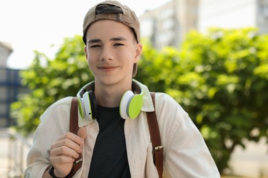 Portrait of teenage boy with headphones outdoors