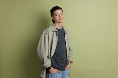 Photo of Portrait of teenage boy on green background