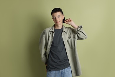 Photo of Portrait of teenage boy on green background