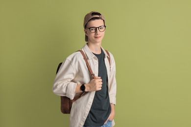 Photo of Portrait of teenage boy with backpack on green background