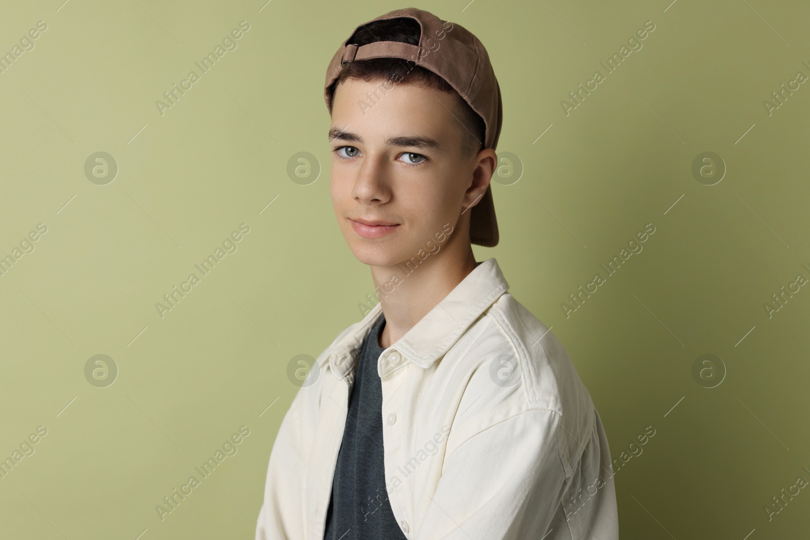 Photo of Portrait of teenage boy on green background