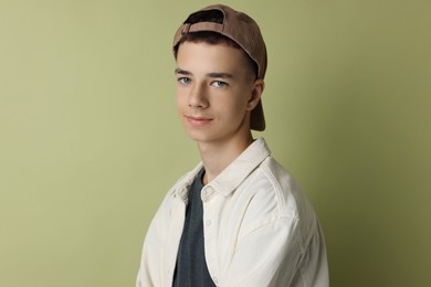 Photo of Portrait of teenage boy on green background