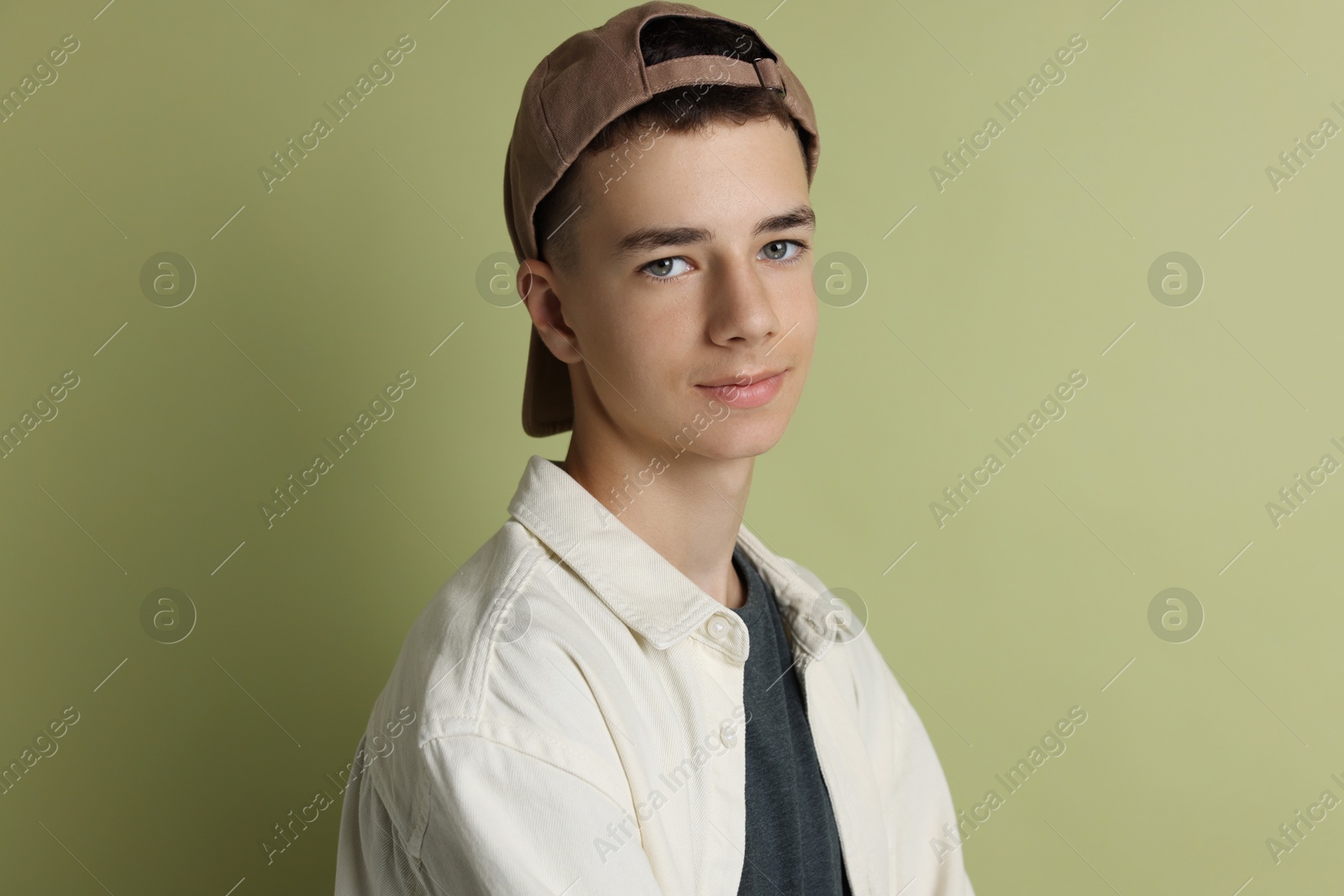 Photo of Portrait of teenage boy on green background