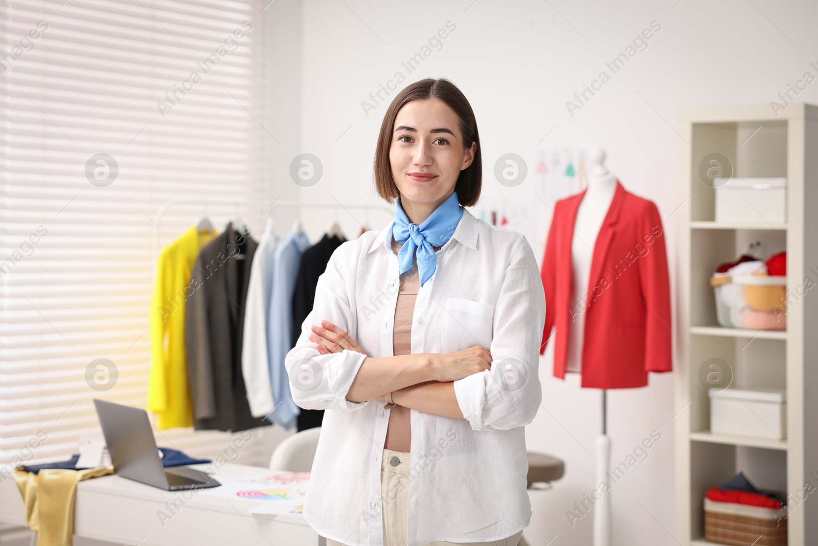 Photo of Portrait of happy fashion designer in workshop