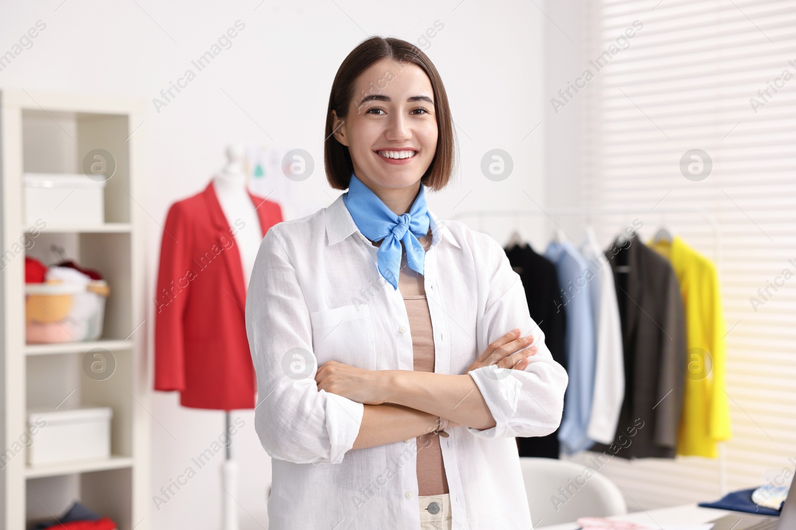 Photo of Portrait of happy fashion designer in workshop