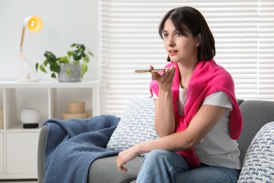 Photo of Beautiful woman recording voice message via smartphone at home