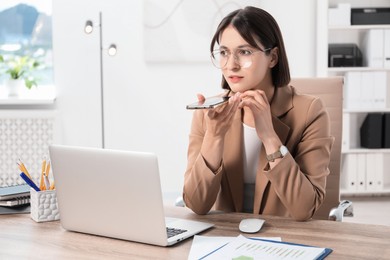 Photo of Beautiful woman recording voice message via smartphone in office