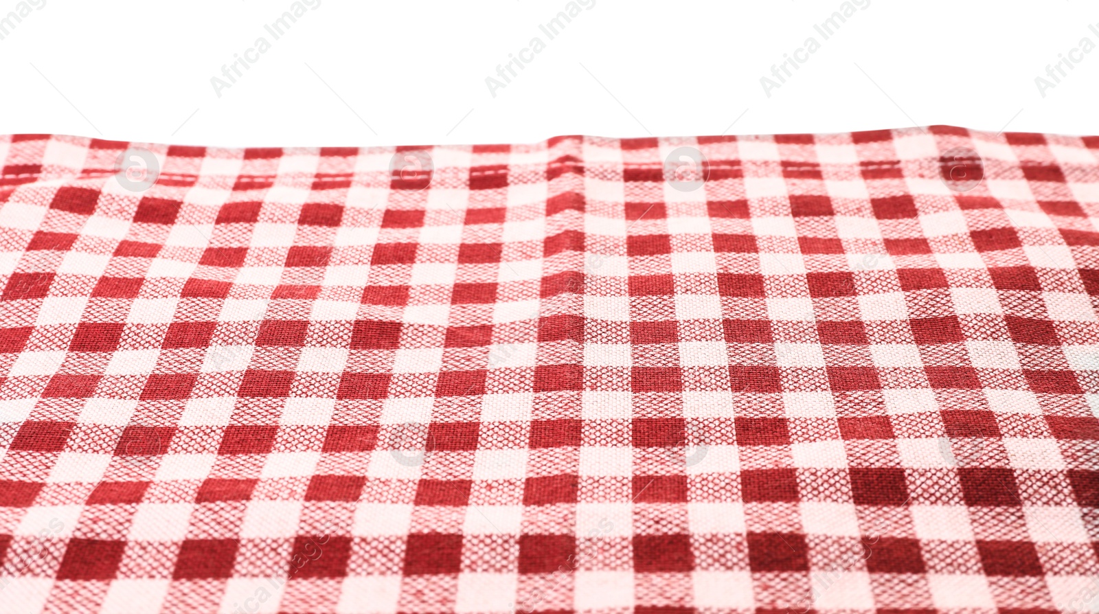 Photo of Folded tablecloth with checkered pattern isolated on white