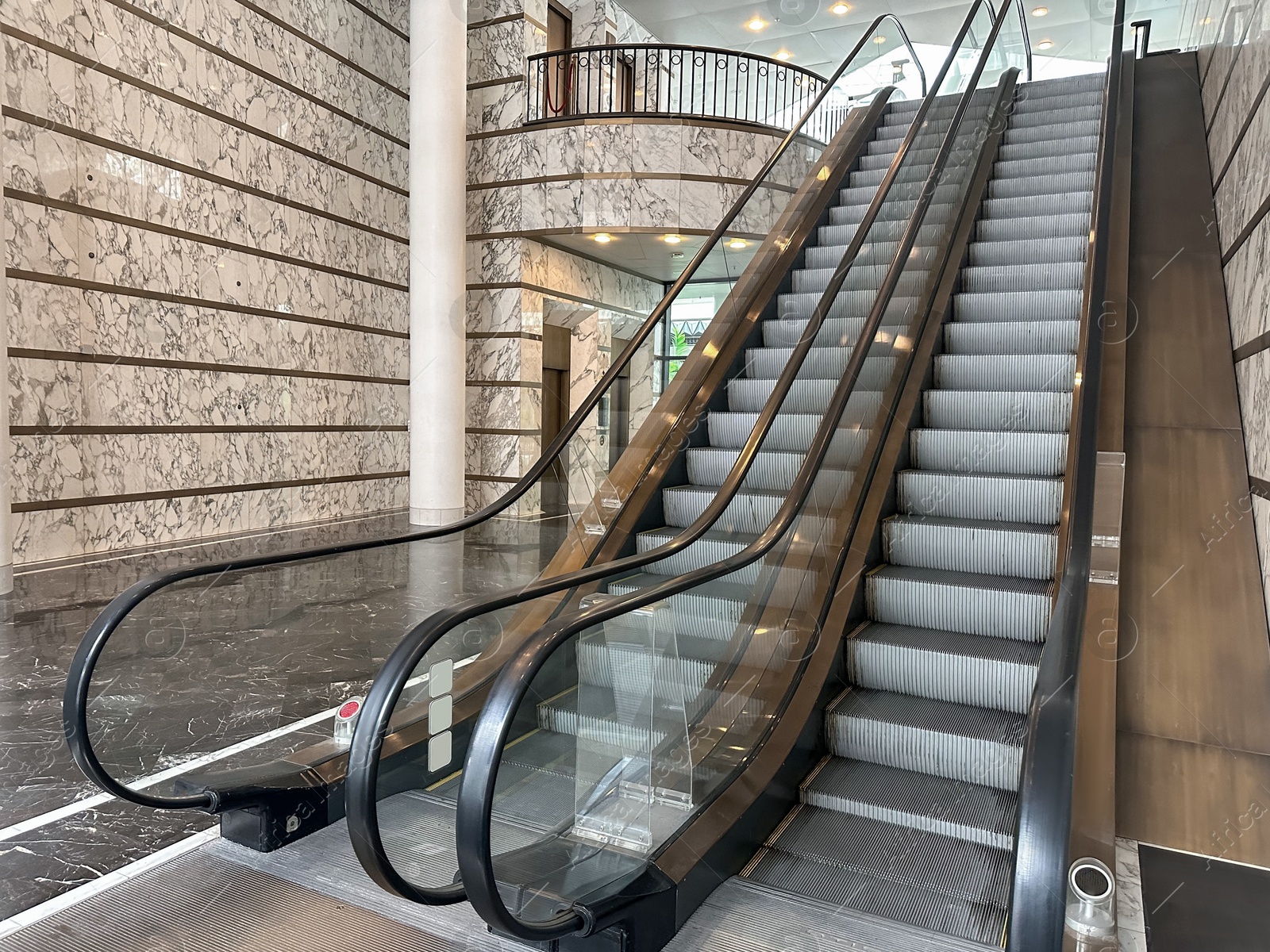 Photo of Modern escalators with handrails in shopping mall