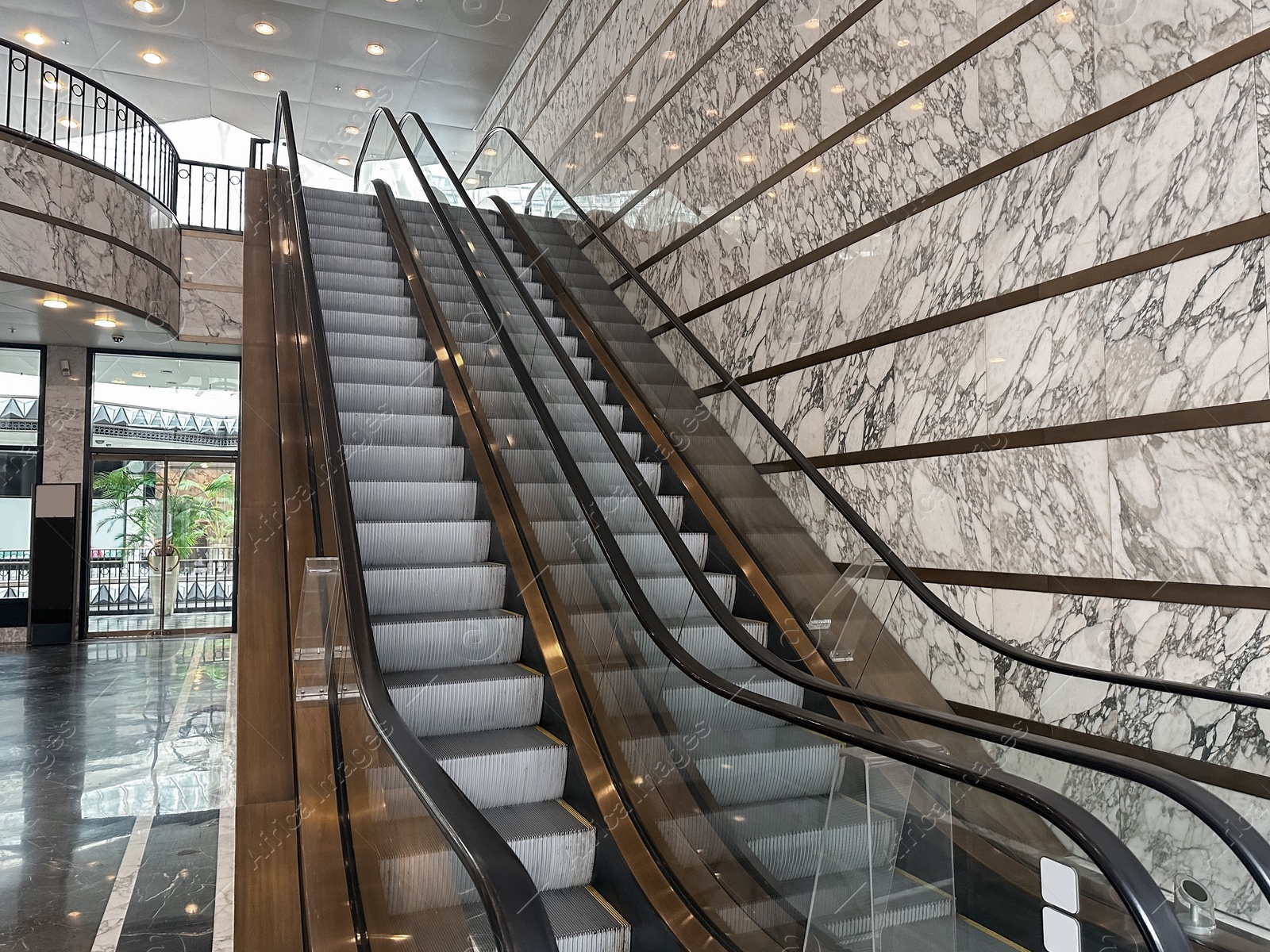 Photo of Modern escalators with handrails in shopping mall