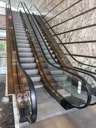 Photo of Modern escalators with handrails in shopping mall