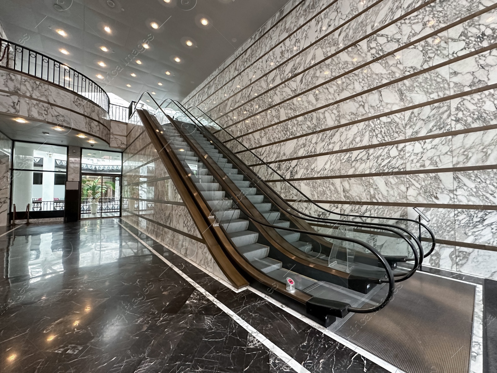 Photo of Modern escalators with handrails in shopping mall