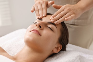 Photo of Attractive woman enjoying face massage, closeup. Beauty procedure