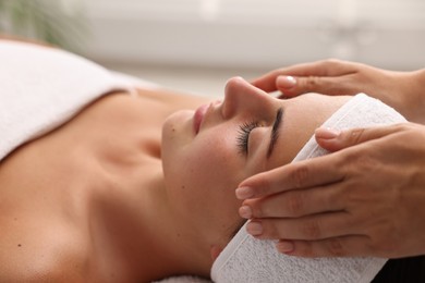 Photo of Attractive woman enjoying face massage, closeup. Beauty procedure