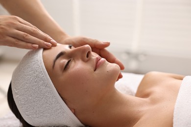 Photo of Attractive woman enjoying face massage, closeup. Beauty procedure